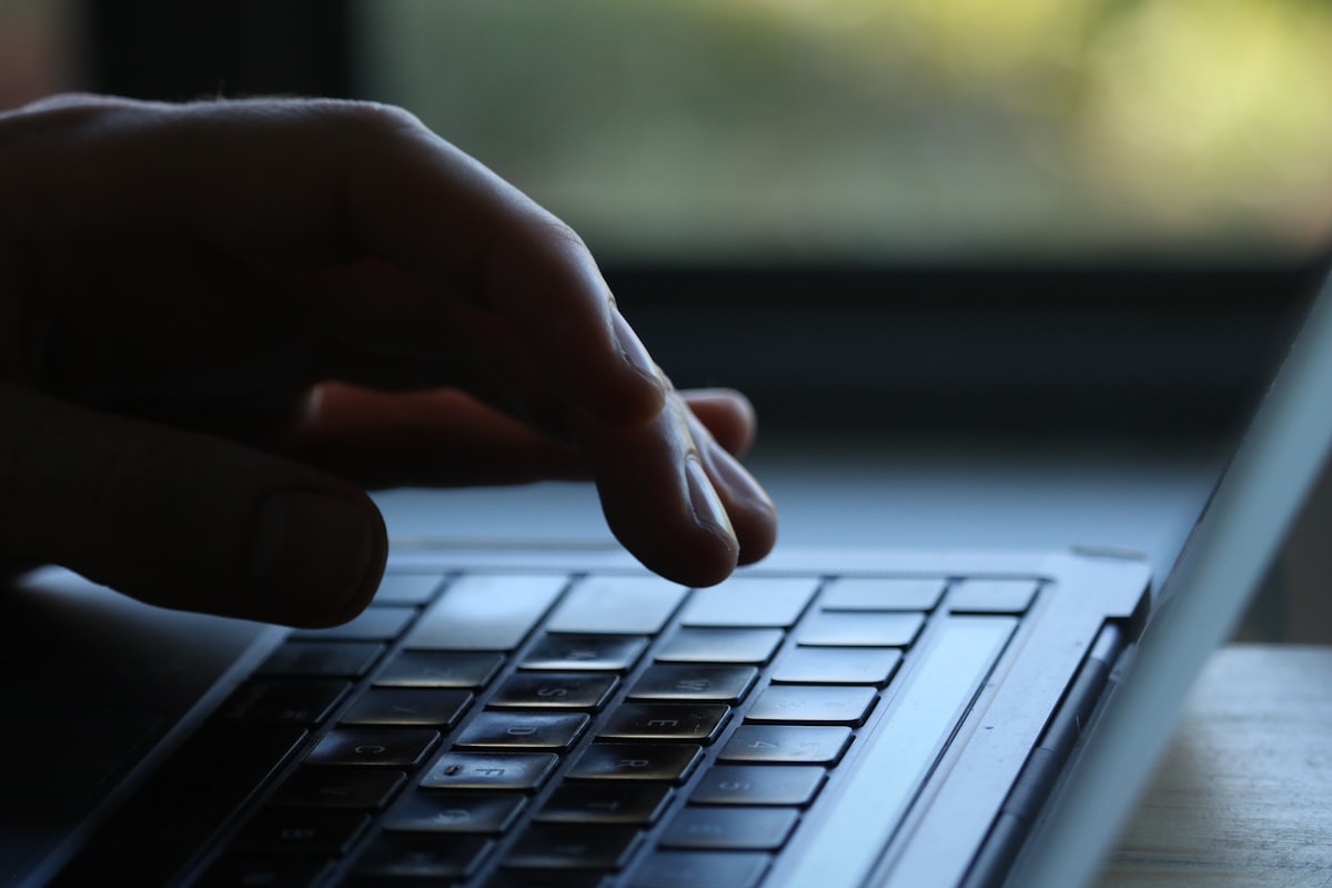 Developer typing on a keyboard writing CI pipeline code