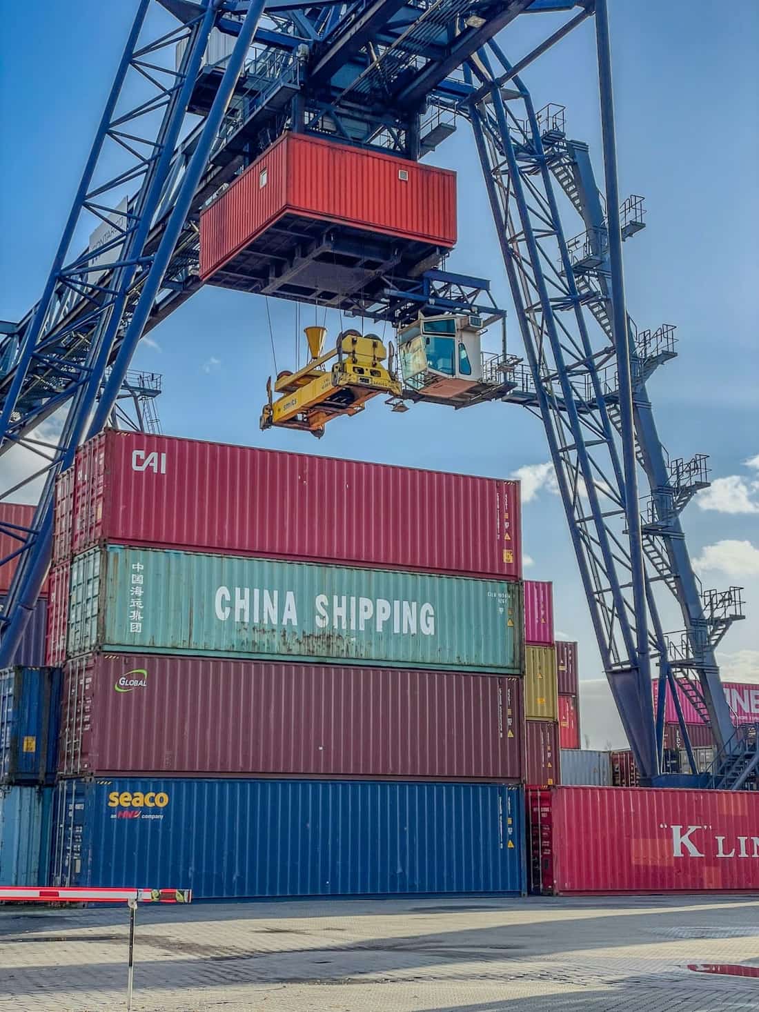 Crane lifting a shipping container representing automated deployment workflows